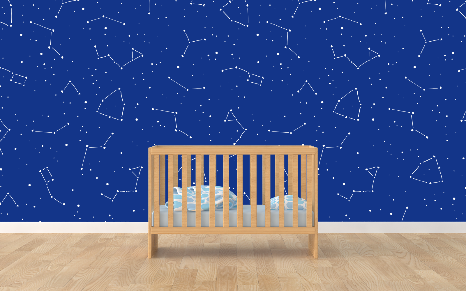Graphic of hand-drawn constellations on a deep blue wall behind a wooden crib on a hardwood floor.